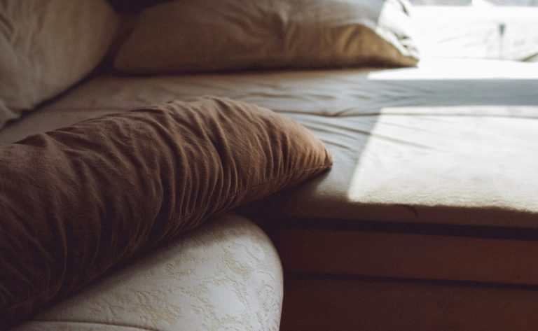 Home 2 Bed with pillows near a window